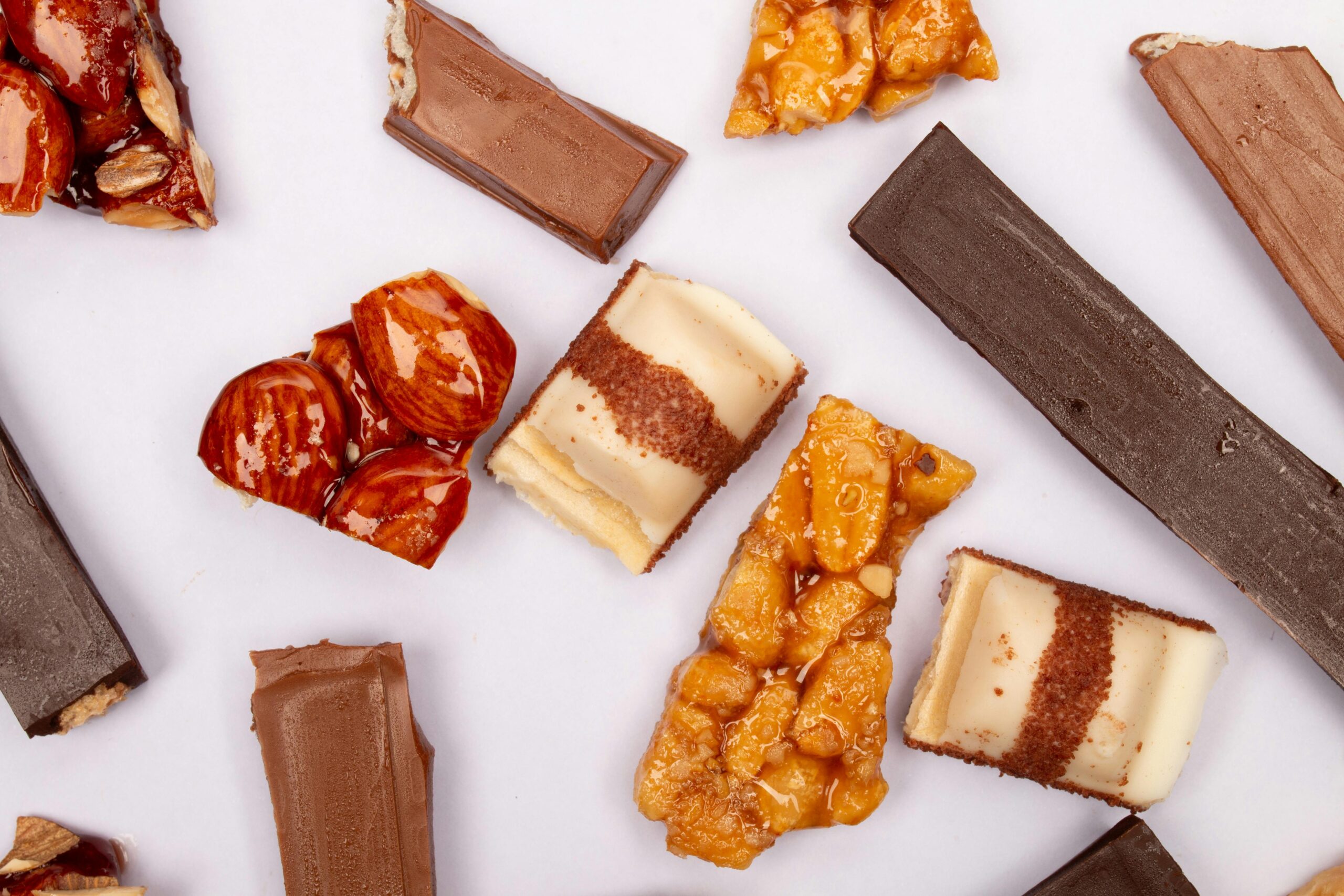 Top view of assorted gourmet chocolates and nuts, showcasing a mixture of flavors and textures.
